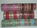 Set of 48 (4 dozen) metal bangles. The set includes some silver/gold and some plain bangles. Available in different colors and sizes to match your saree, salwar, lehenga or kurti.