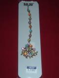 Fancy Mang tika with multi-colored stones.  The entire length of the maang tika is covered with multicolored stones.  There is a hook which can be attached into the hair. Can be worn by adults and kids.
