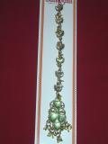 Maang tikka in gold color with colored stones.  The pendant is covered with stones and has dangling beads in the front.  There is a hook which can be attached into the hair. Can be worn by adults and kids. Available in different colors.
