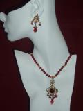 Gorgeous kundan necklace from Rajasthan.  The necklace consists of an exquisite kundan pendant attached to a necklace made of gold colored & wine-red beads.  Makes a very unique Christmas gift.<br>
Matching earrings optional.