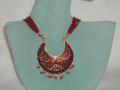Beautiful handmade Rajasthani minakari necklace.  The necklace consists of an exquisite minakari pendant on an adjustable, red, bead necklace.  The pendant has a traditional Rajasthani motif hand-painted on it in red, black, green, blue, yellow & white.  The length of the necklace is adjustable.<br>
Comes in a red and gold box.