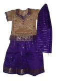 Purple and tan pattu pavadai for kids.  The long tan top has a thick purple, gold and silver at the sleeves and base and has bead work all over. The purple skirt has golden stripes and has a thick gold and silver border at the base. The rest of the skirt is covered with tiny gold bootis.  The skirt is flared and has a drawstring waist - the drawstring is a traditional white, cotton one.  The dupatta has gold stripes and gold bootis. This is a very typical clothing style in South India. Sizes available for girls aged 1 year old and up.
